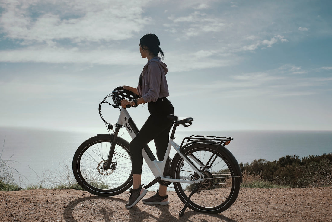 man in white shirt and black shorts riding black bicycle during daytime